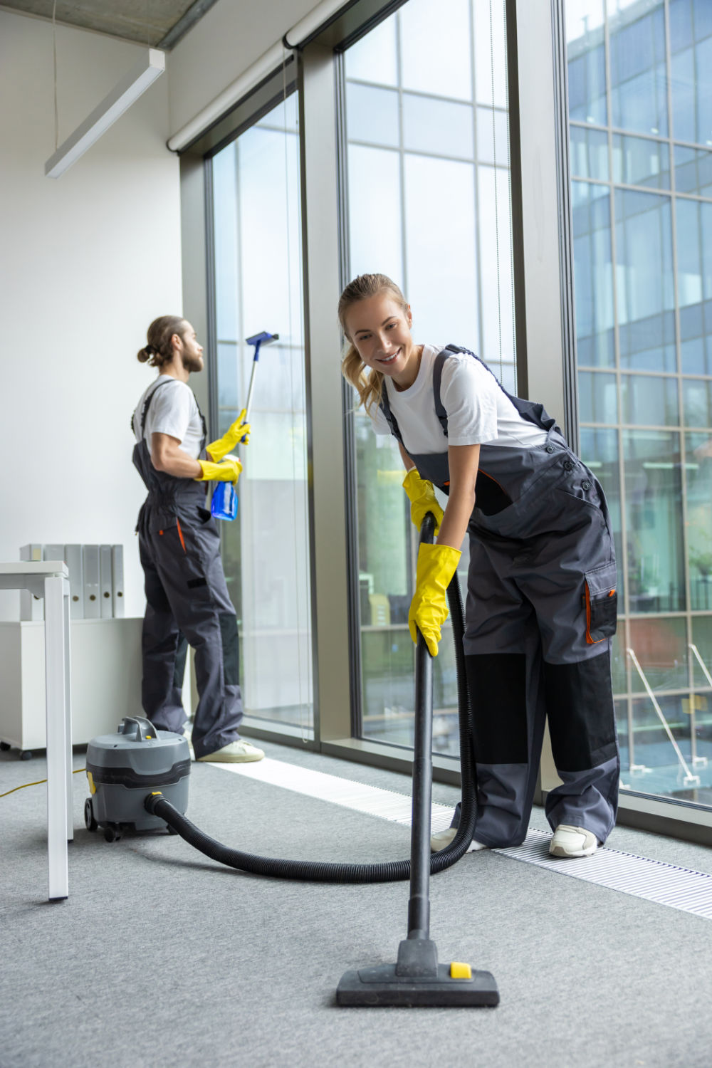 housekeeping-team-cleaning-the-conference-room-and-looking-busy-and-involved